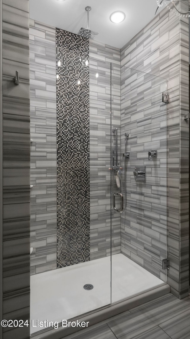 bathroom featuring tile patterned flooring and a shower with shower door