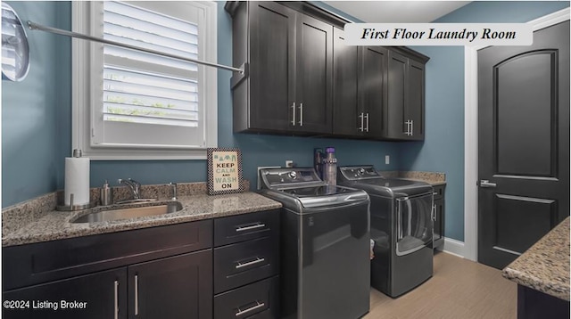 laundry room with cabinets, light hardwood / wood-style flooring, sink, and independent washer and dryer