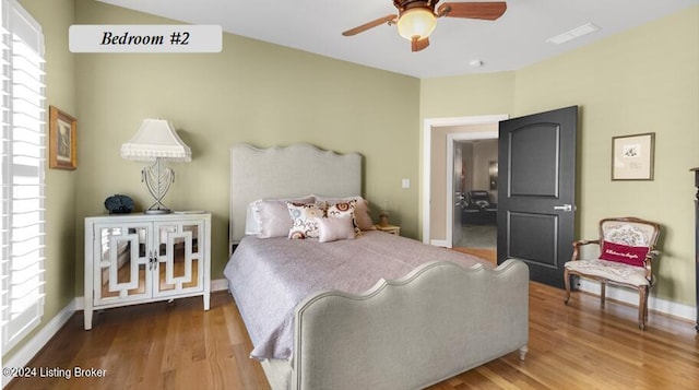 bedroom with hardwood / wood-style flooring and ceiling fan