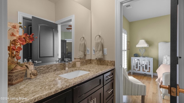 bathroom featuring hardwood / wood-style flooring, ceiling fan, and vanity