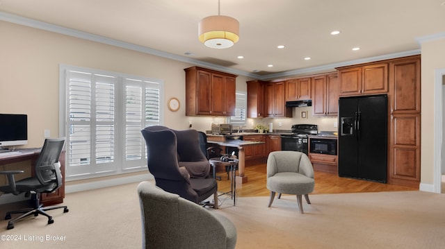 kitchen with pendant lighting, sink, ornamental molding, black appliances, and light wood-type flooring