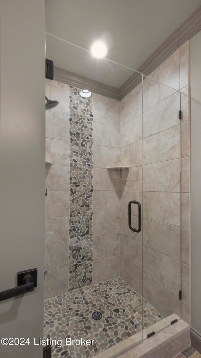 bathroom with a shower with door