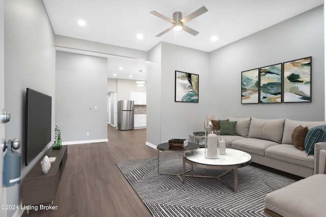 living room featuring hardwood / wood-style flooring and ceiling fan