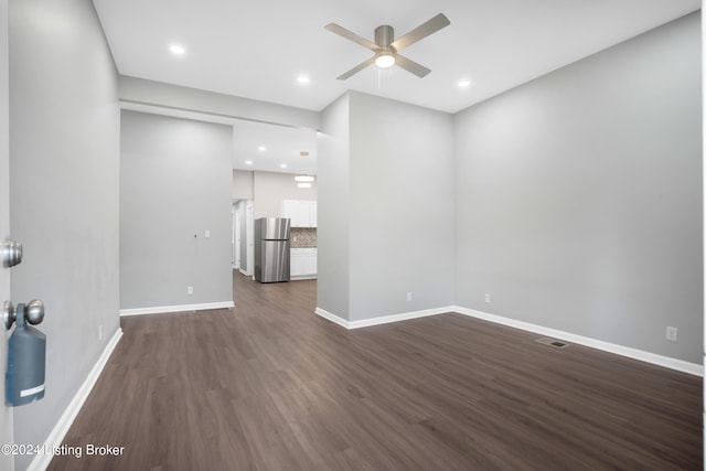 spare room with ceiling fan and dark hardwood / wood-style flooring