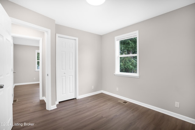 unfurnished bedroom with dark hardwood / wood-style flooring