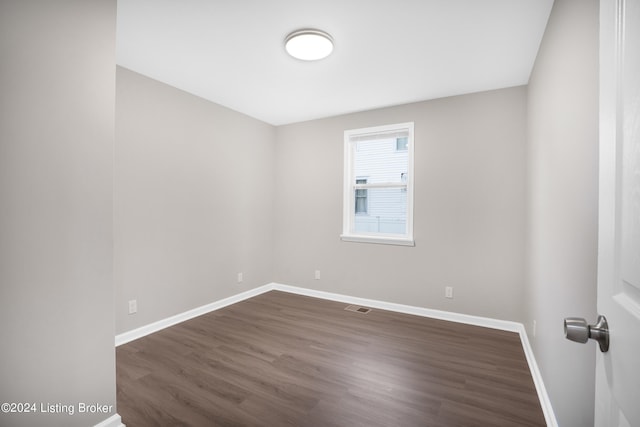 unfurnished room featuring dark hardwood / wood-style flooring