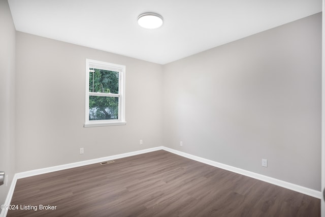 spare room with dark hardwood / wood-style flooring