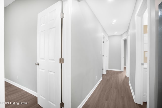 hall with dark hardwood / wood-style flooring