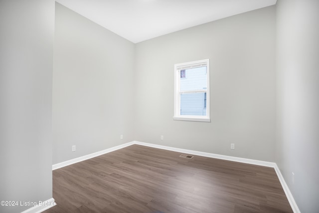 empty room featuring dark wood-type flooring