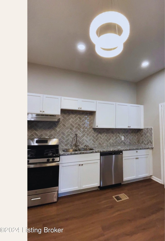 kitchen with white cabinetry, dark hardwood / wood-style floors, stainless steel appliances, and sink