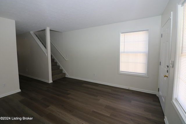 unfurnished living room featuring dark wood-type flooring