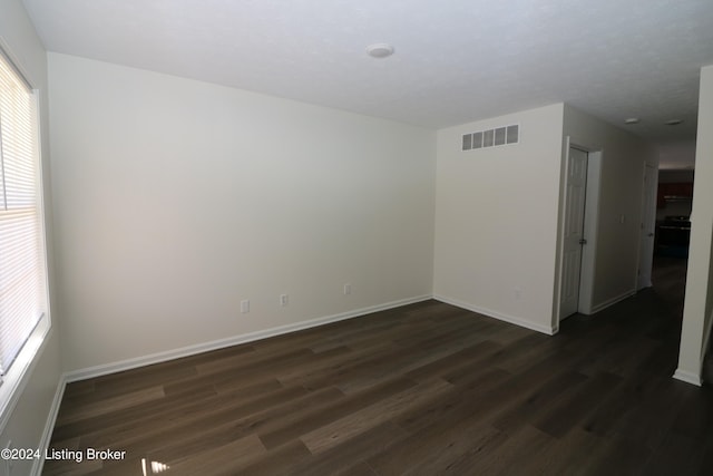 unfurnished room featuring dark hardwood / wood-style flooring