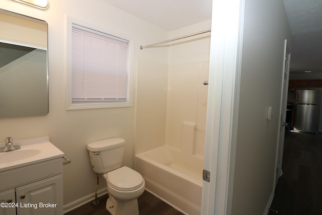 full bathroom with hardwood / wood-style flooring, vanity, shower / bath combination, and toilet