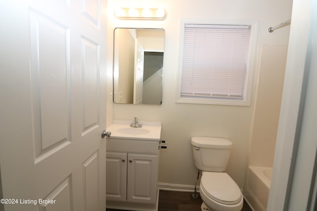 bathroom with hardwood / wood-style flooring, vanity, and toilet