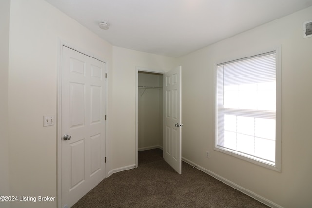 unfurnished bedroom featuring dark colored carpet