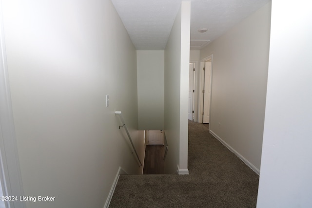 corridor with dark colored carpet