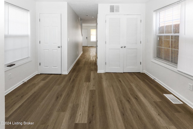 corridor featuring dark hardwood / wood-style floors