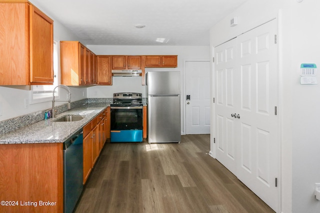 kitchen featuring sink, appliances with stainless steel finishes, dark hardwood / wood-style floors, and light stone counters