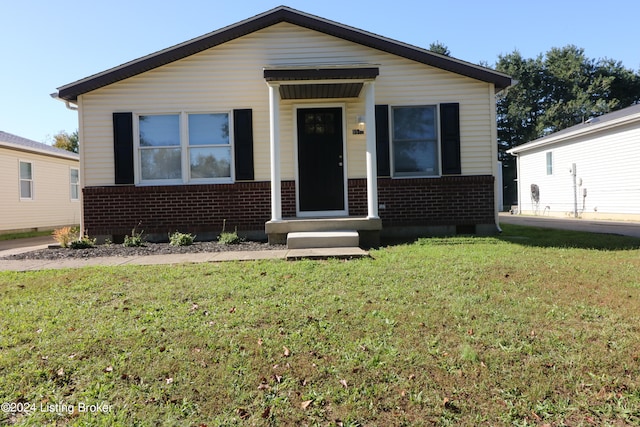 bungalow-style home with a front lawn