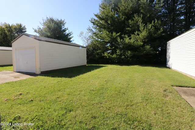 view of yard featuring an outbuilding and a garage