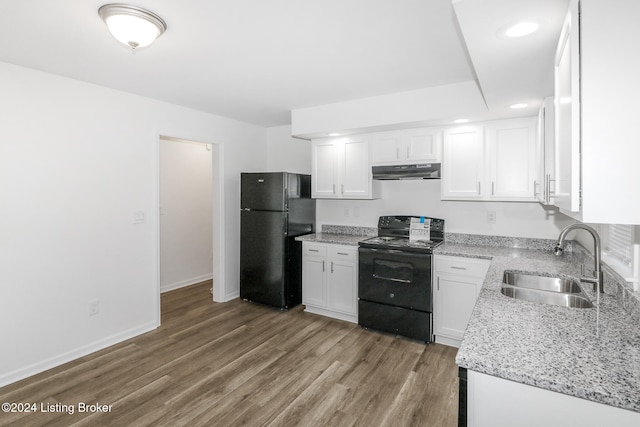 kitchen featuring sink, white cabinets, black appliances, wood-type flooring, and light stone countertops