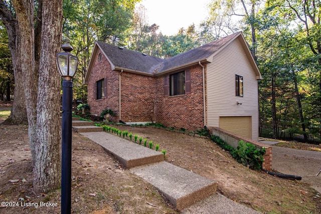 view of side of home featuring a garage