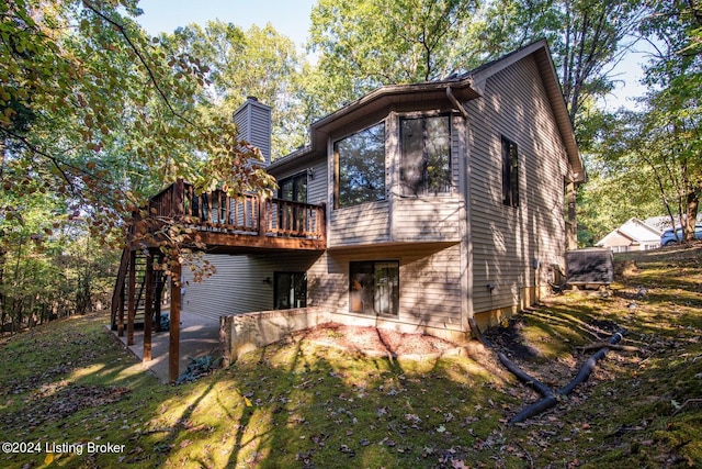 rear view of property featuring a deck and a patio