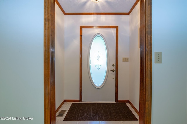 doorway to outside with crown molding, light tile patterned floors, and a textured ceiling