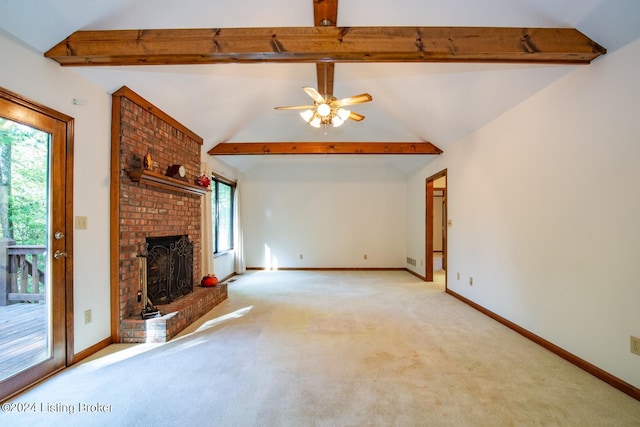 unfurnished living room with a brick fireplace, ceiling fan, lofted ceiling with beams, and light carpet