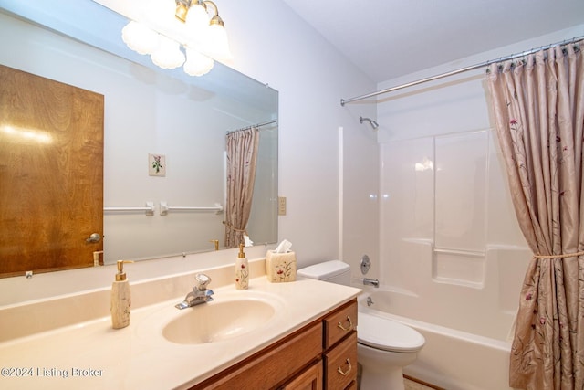 full bathroom with vanity, shower / bath combo with shower curtain, and toilet