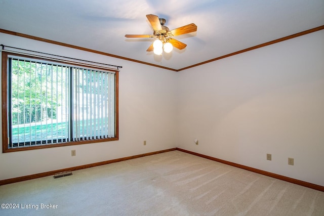 unfurnished room featuring carpet floors, crown molding, and ceiling fan