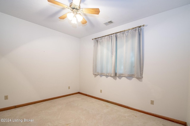 spare room featuring light carpet and ceiling fan