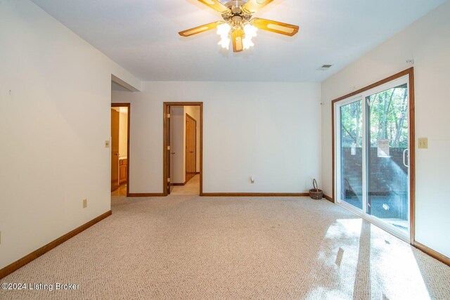 carpeted spare room with ceiling fan