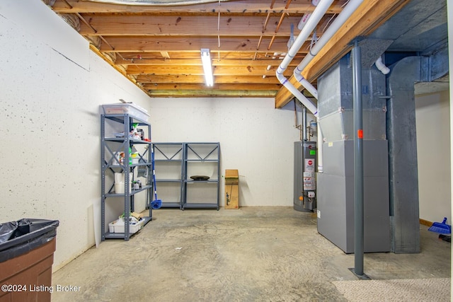 basement featuring gas water heater and heating unit