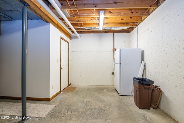 basement with white fridge