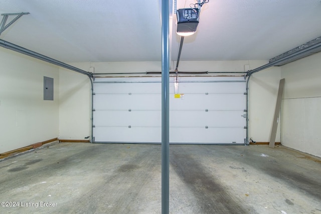 garage with a garage door opener and electric panel