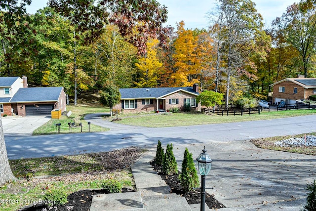 view of front of home with a garage and a front yard