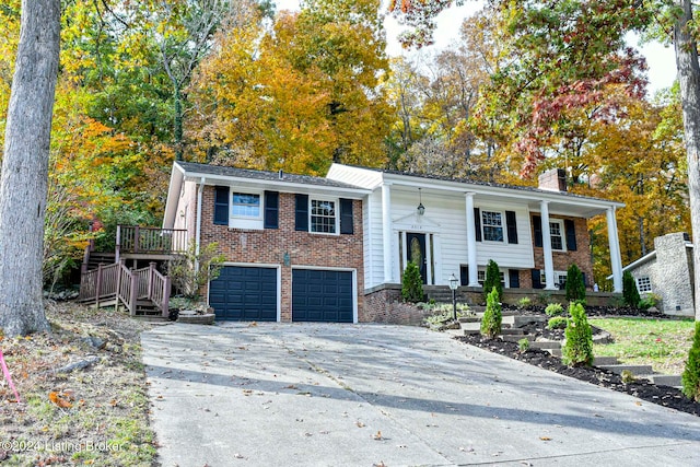 raised ranch with covered porch and a garage