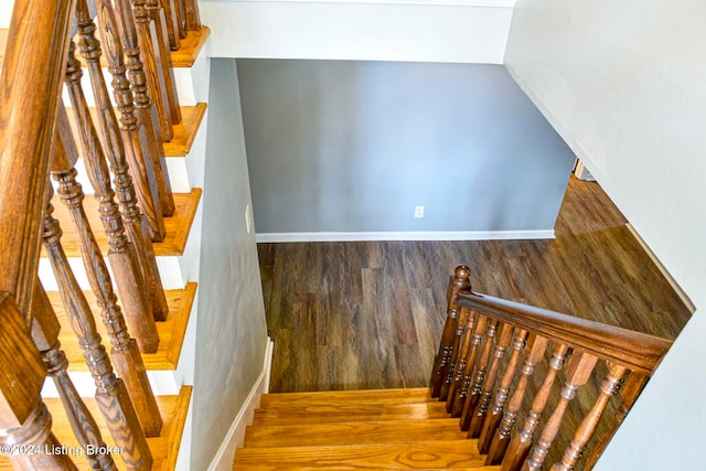 stairs with hardwood / wood-style flooring