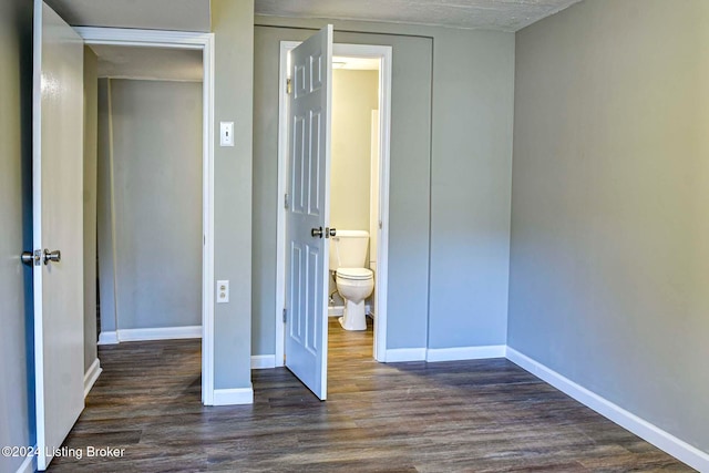 unfurnished bedroom featuring dark hardwood / wood-style floors