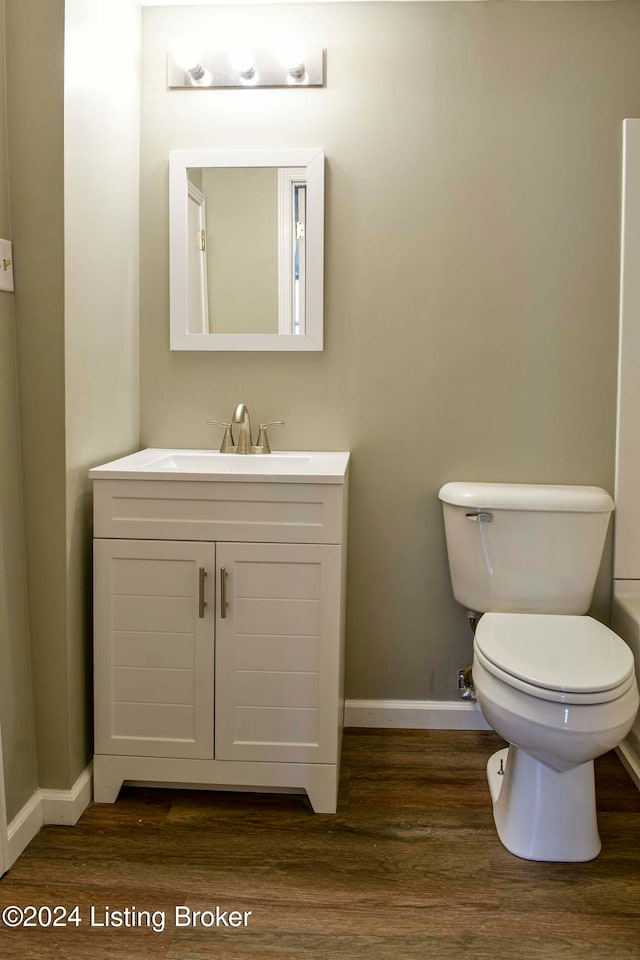 bathroom featuring hardwood / wood-style flooring, vanity, and toilet