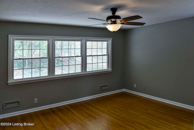 unfurnished room featuring ceiling fan and dark hardwood / wood-style floors