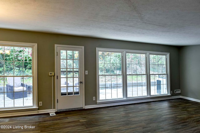 doorway to outside with dark hardwood / wood-style floors and a healthy amount of sunlight