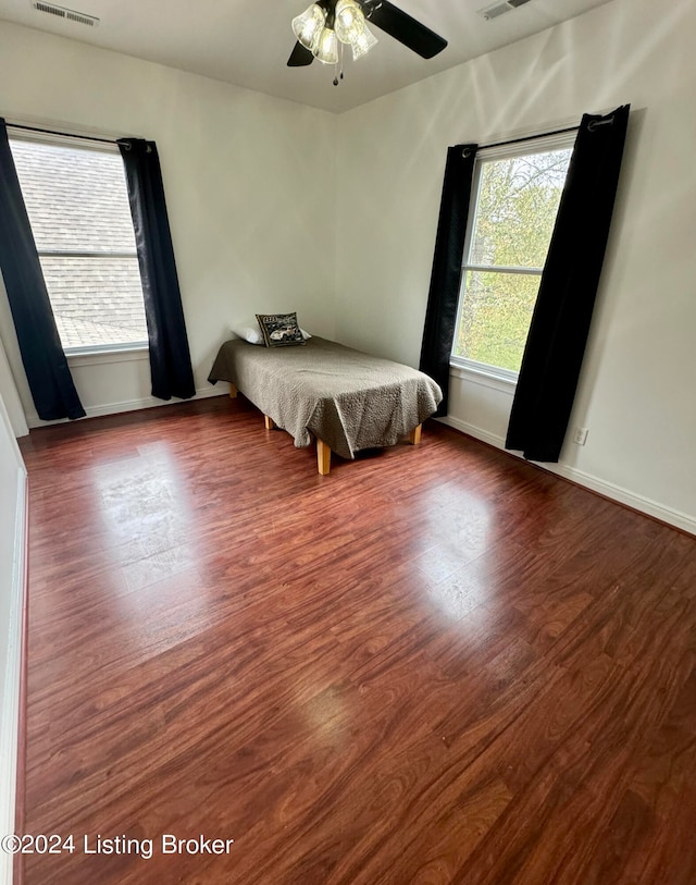 bedroom with ceiling fan and wood-type flooring