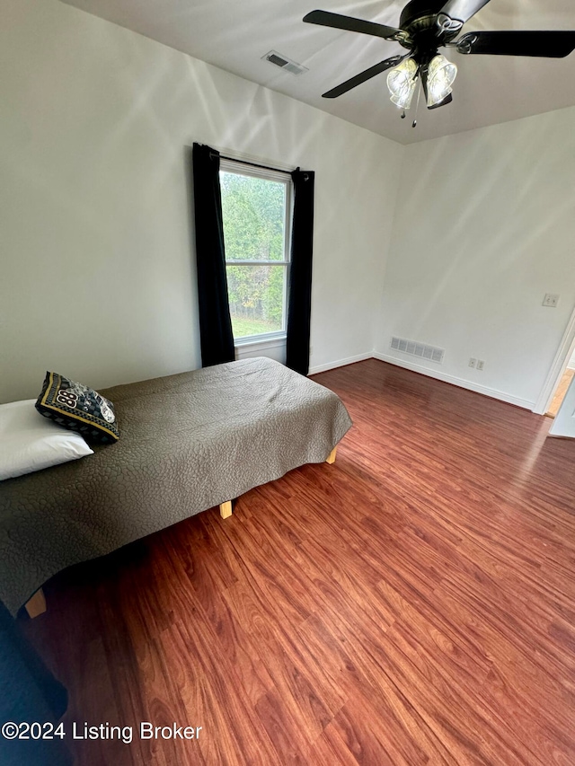 bedroom featuring hardwood / wood-style flooring and ceiling fan