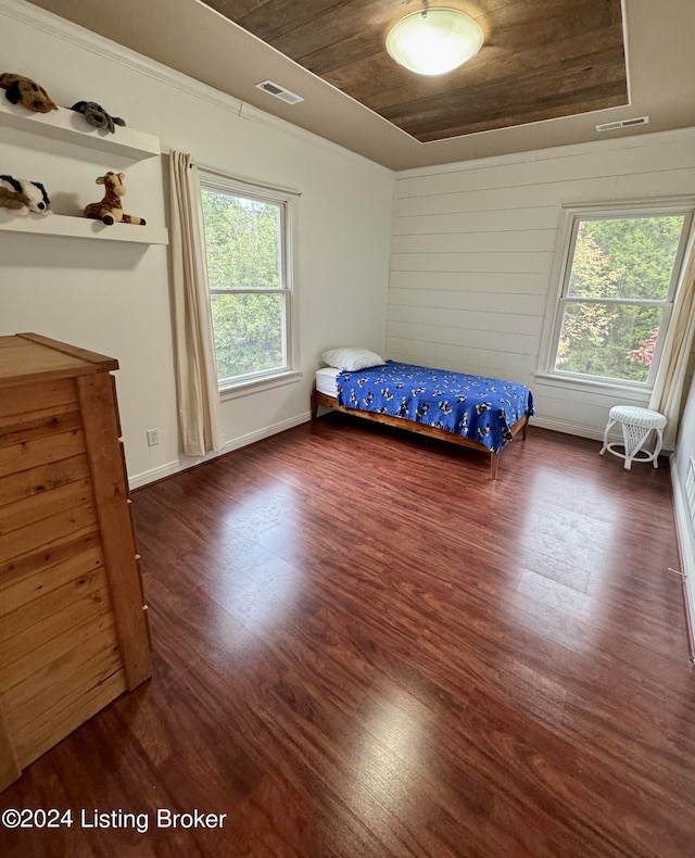 bedroom featuring dark hardwood / wood-style flooring and wooden ceiling