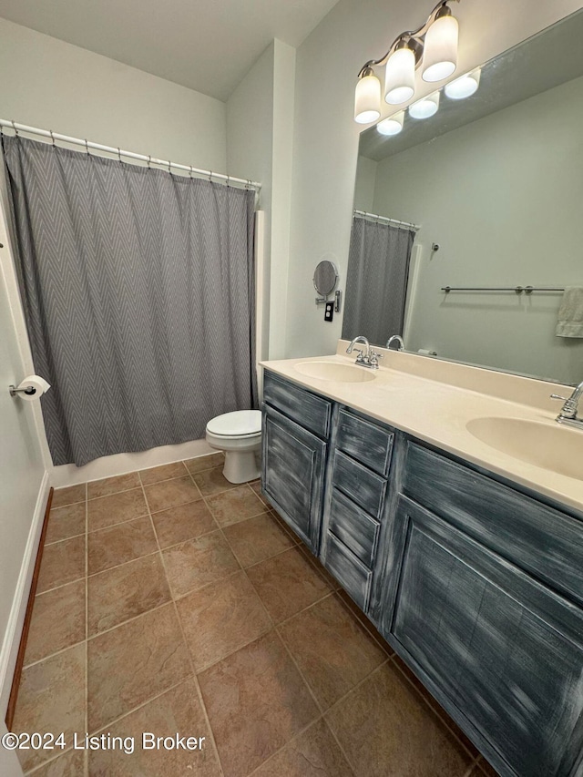 bathroom featuring vanity, tile patterned floors, and toilet