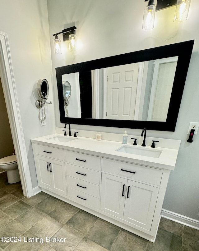 bathroom featuring vanity and toilet