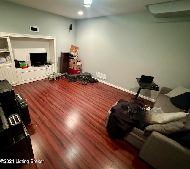 living room with lofted ceiling and wood-type flooring