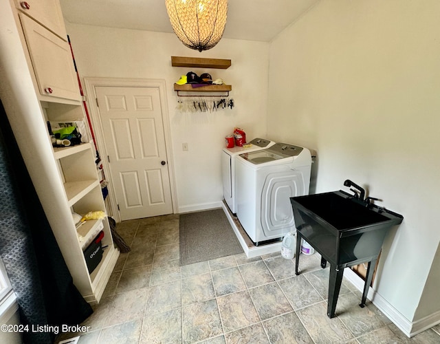 laundry area featuring washer and clothes dryer and cabinets